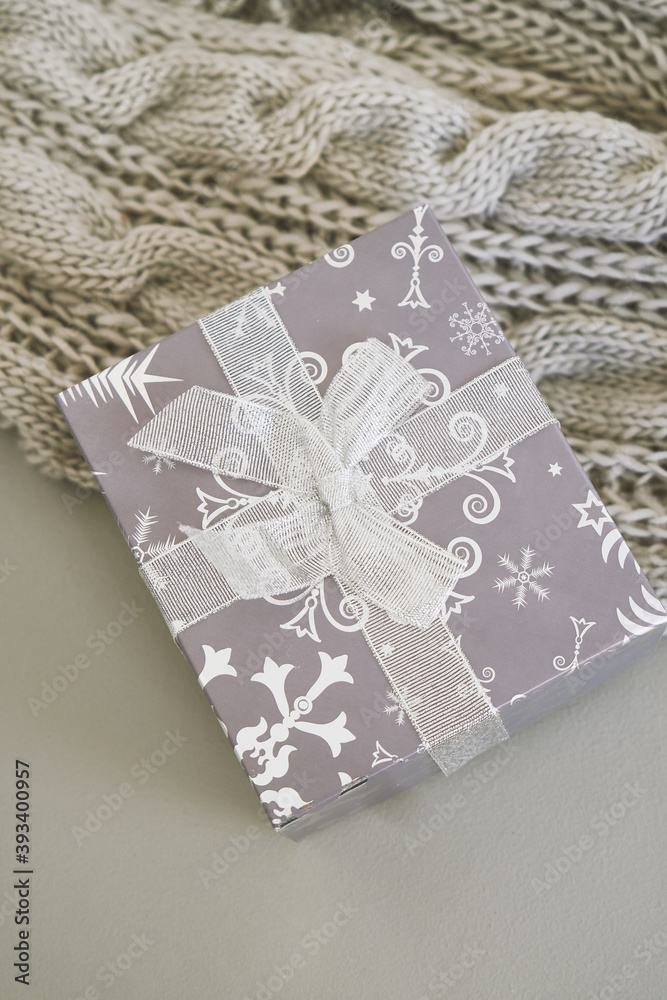 Christmas gifts ,grey knitted blanket on grey background
