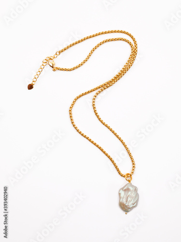 Luxury elegant golden chain with baroque pearl pendant isolated on white background