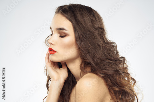 Elegant woman with bare shoulders red lips glamor attractive look cropped look