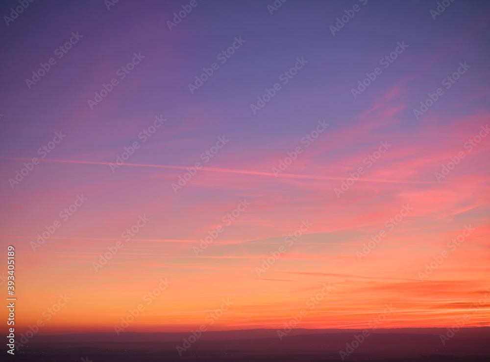 Evening colorful purple-pink sky with red clouds and orange horizon. Aerial photography, sky over the whole photo. Photo perfect for background exchange.