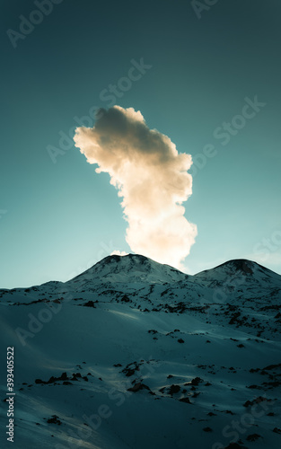 Volcano erupting during sunrise, in snowy season  © Producciones
