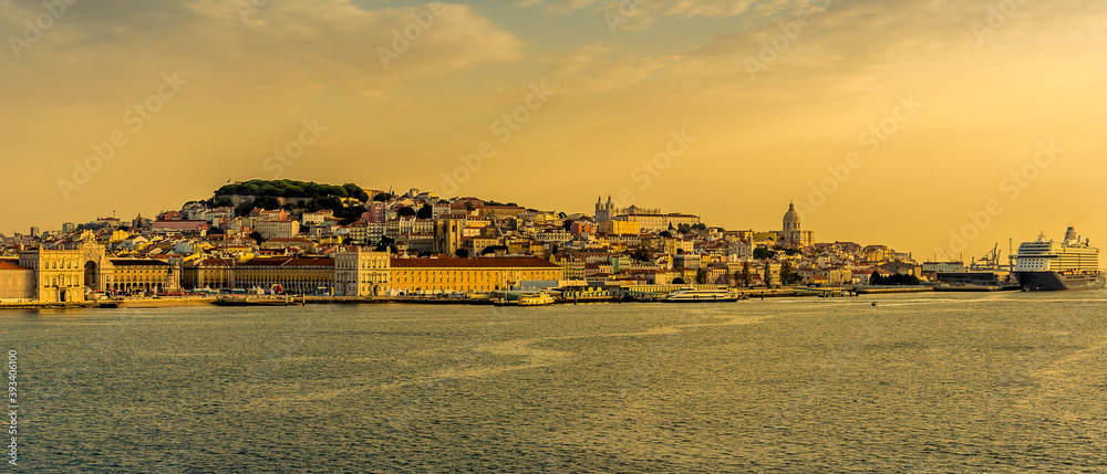 A close-up view of the Alfama district of Lisbon, Portugal from the river Tagus in the golden early morning light at sunrise in Autumn