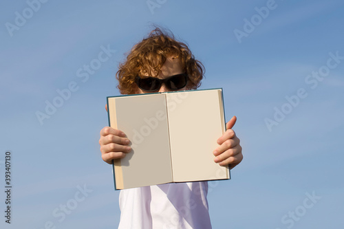 Text. Ad. Advertising. Empty space for text.  Student  holding an empty open book
