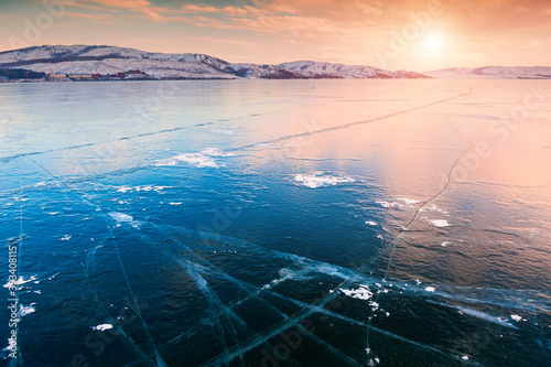 Ice on the frozen lake at sunset. Beautiful winter landscape. Bannoye lake in South Ural  Russia