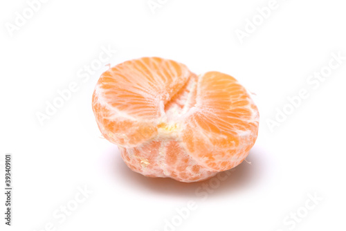 Closeup of peeled tangerine on white background