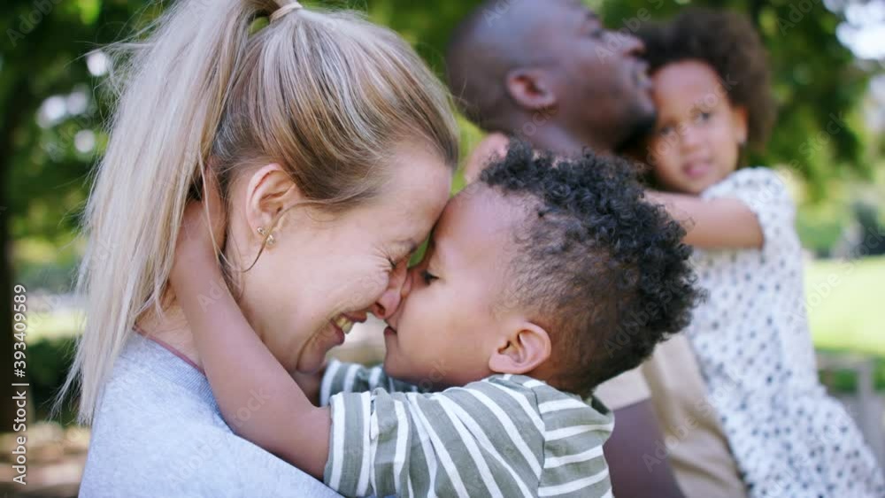 Multiracial family on walk in public park.