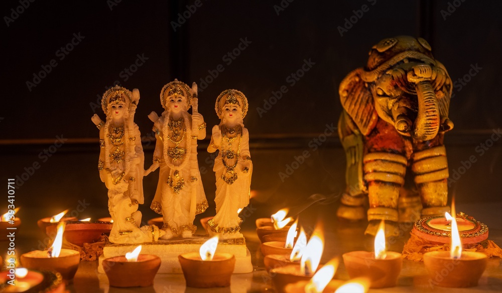 Lord Ram  idol brightening with Diya candle light on the occasion of Diwali. Diwali is the major festival of lights in India. - obrazy, fototapety, plakaty 