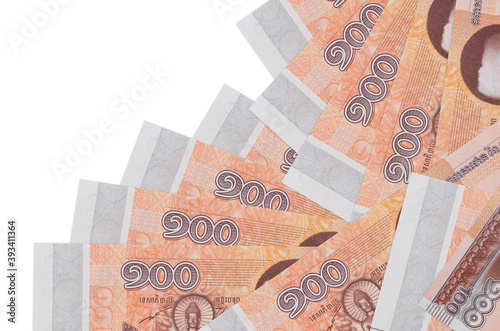 100 Cambodian riels bills lies in different order isolated on white. Local banking or money making concept photo