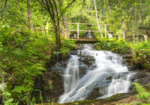 .waterfall in the forest and a wooden bridge