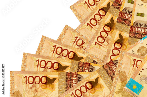 1000 Kazakhstani tenge bills lies in different order isolated on white. Local banking or money making concept photo