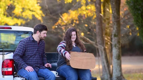 Couple, with pick-up making plans for traveling with map coffee and picnic basket