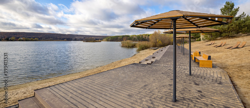 View of the deserted beach with umbrella and deckchairs. Landscape: sea and wave on coast with relaxation view.