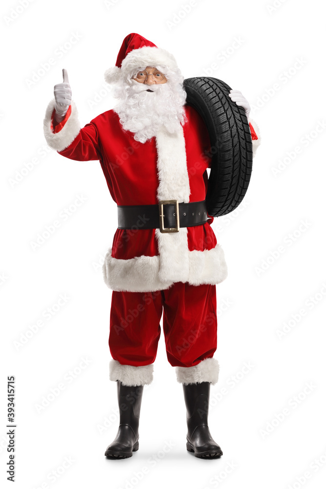 Full length portrait of santa claus holding a car tire and showing thumbs up Full length portrait of santa claus holding a car tire and showing thumbs up