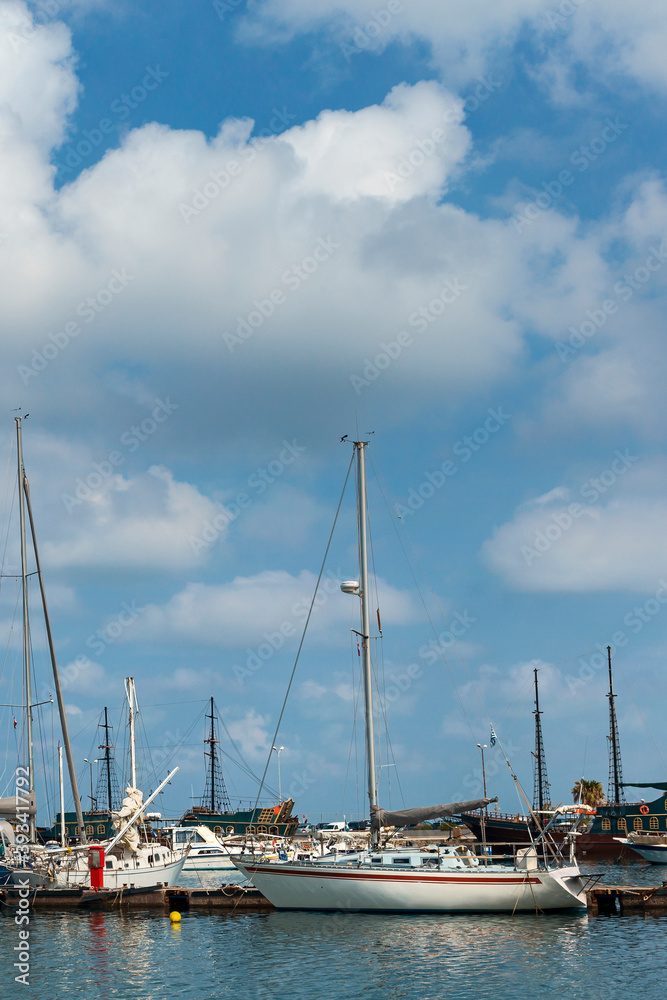 large and small sailboats in the harbor of the Greek city of Rethymno against the backdrop of a beautiful cloudy sky