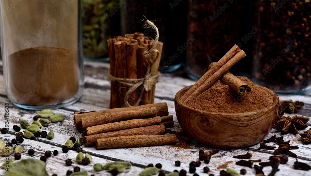 Bunch of cinnamon sticks on a white wooden table Bunch of cinnamon sticks on a white wooden table