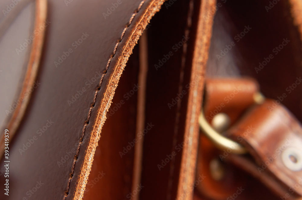 Fashionable brown women's bag made of genuine leather close-up. Leather bag texture. Fashion concept Details of leather bag belt metal buckle clasp thread stitching macro shot Stylish female accessory - obrazy, fototapety, plakaty 