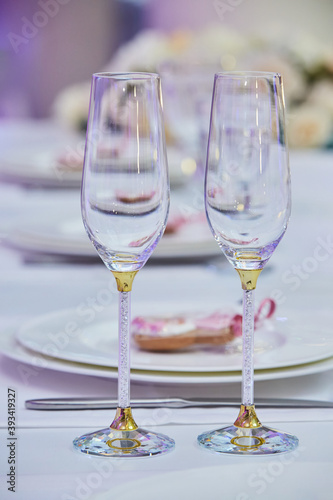 Two wedding glasses for champagne or wine. The concept of drinks and the wedding table layout.