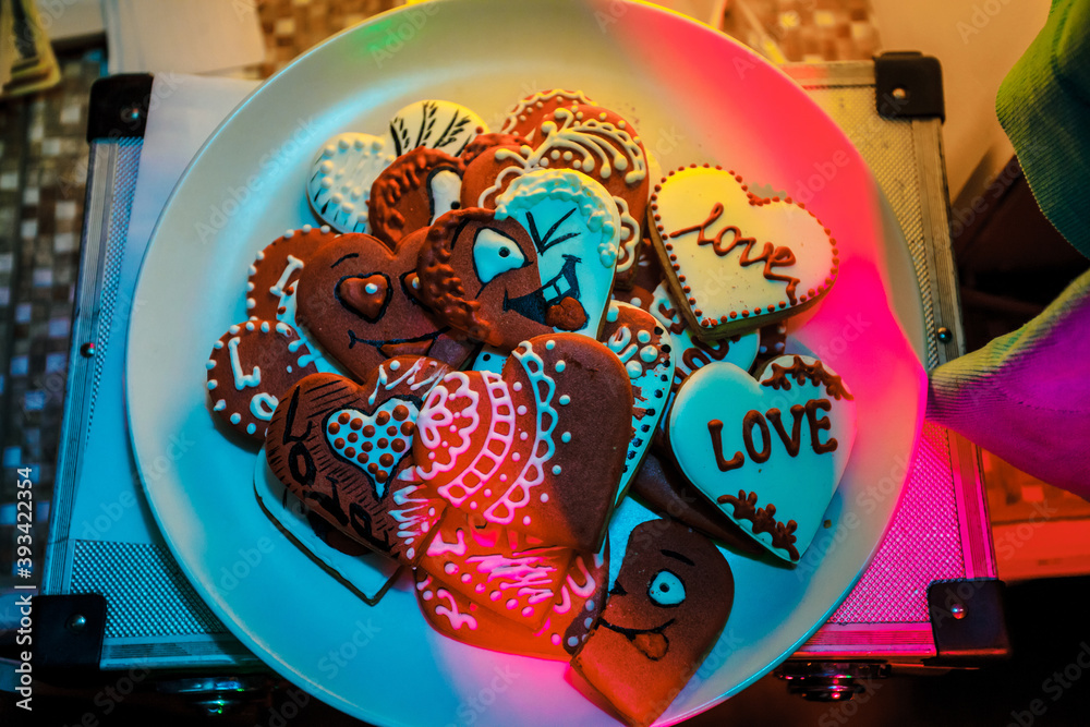 Fototapeta premium Valentines day. Romantic sweet heart cake on the white plate. Red heart shaped cookies on a white plate, symbol of love.