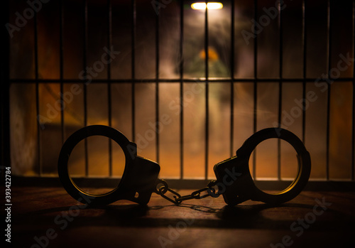 Jail or prison cell. Man in prison man behind bars concept. Old dirty grunge prison miniature. Dark prison interior creative decoration. Selective focus photo