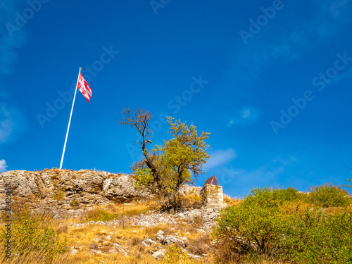 hill with stone path and templar flag in the French Riviera back country photo