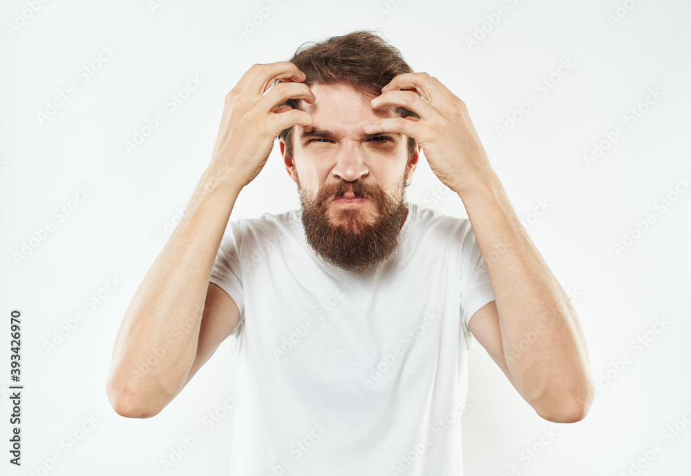 Naklejka premium A man with a thick beard gestures irritably with his hands stress emotions