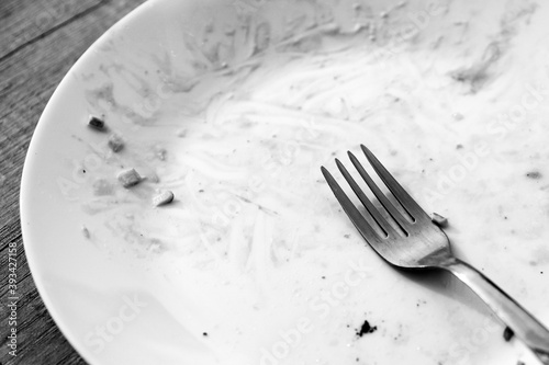 DIRTY PLATE AND TABLEWARE AFTER a MEAL.Top view of empty plate