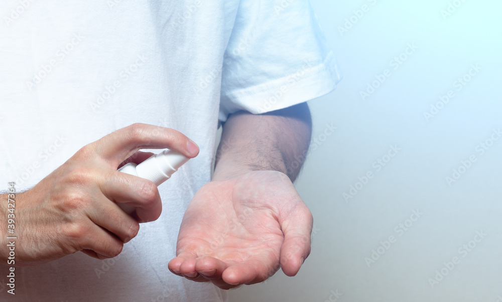 Fototapeta premium Hand of man that applying alcohol gel to make cleaning and clear germ, bacteria, Health care concept