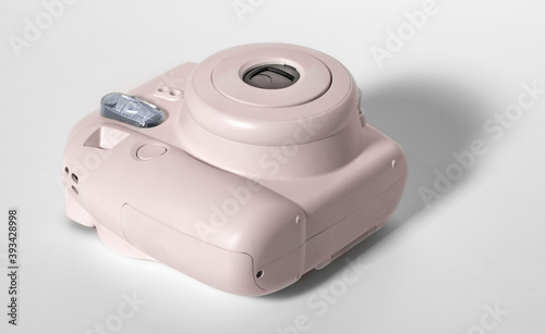 Old pink plastic camera on a white background.