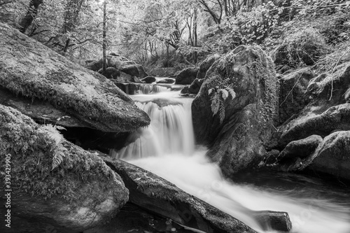 Long exposure of a waterfall on the Hoar Oak Water river flowing through the woods at Watersmeet in Exmoor National Park photo