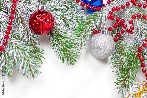 New Year and Christmas decorations with green fir tree branches and Xmas traditional decor with copy space for greeting invitation cards © KatMoy
