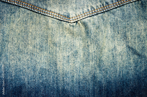 clothing items blue stonewashed faded jeans cotton fabric texture with seams, clasps, buttons and rivets, macro, close-up