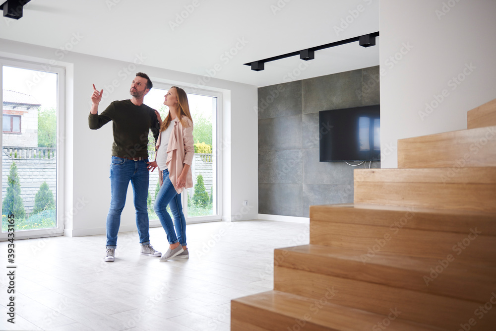 Couple looking around in empty flat Couple looking around in empty flat