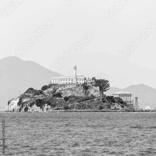 Waterfront with Alcatraz Island in background against sky at San Francisco, California, USA