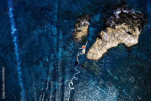 Greece, Crete, Bungee Jumping, woman jumping bungee over sea photo