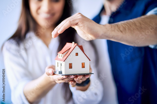 Close-up of couple holding model of new home