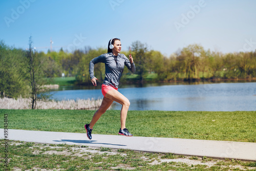 Female jogger running at park photo