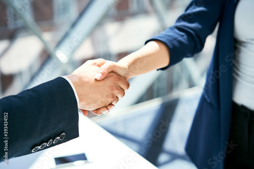 Close-up of handshake of businesswoman and businessman photo