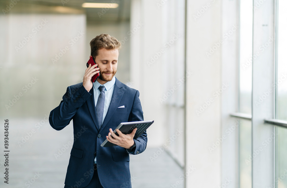 Businessman holding tablet talking on the phone Businessman holding tablet talking on the phone