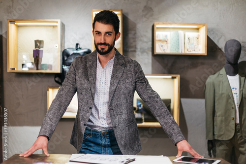 Portrait of confident man in menswear shop photo