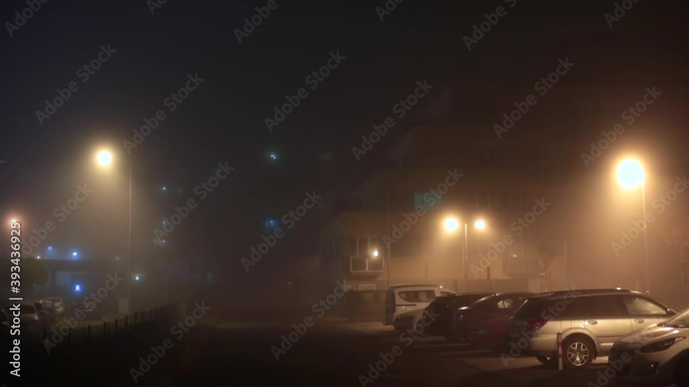 Lanterns illuminate the courtyard. Parking cars at night near the house. Organization of modern urbanism of space use. Camera movement. Lanterns illuminate the courtyard. Parking cars at night near the house. Organization of modern urbanism of space use. Camera movement.