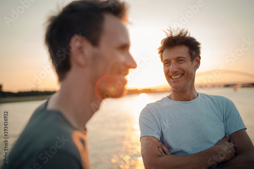 Two friends meeting at sunset, spending the evening talking photo