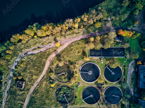 Aerial view of water treatment plant by lake on sunny day