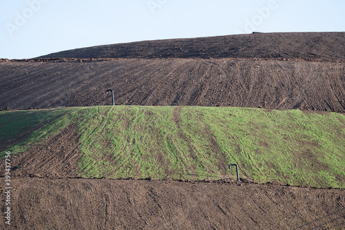 Hillside of recultivated landfill with metan gas pipes