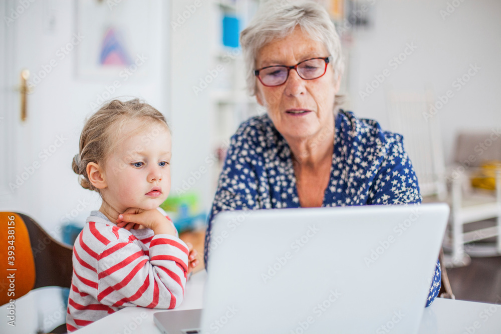 Grandmother and granddaughter using laptop Grandmother and granddaughter using laptop
