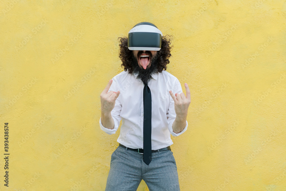 Man sticking out tongue while gesturing against wall Man sticking out tongue while gesturing against wall