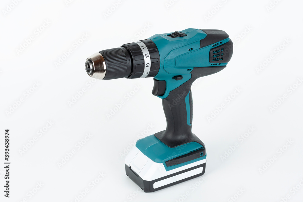 Green cordless hammer screwdriver drill on white background. The tool can be used as a drill hammer or a screwdriver or flat drill The drill has two speed an keyless chuck.