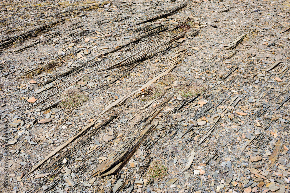 Abstract detail of parallel layered rocks and gravel.