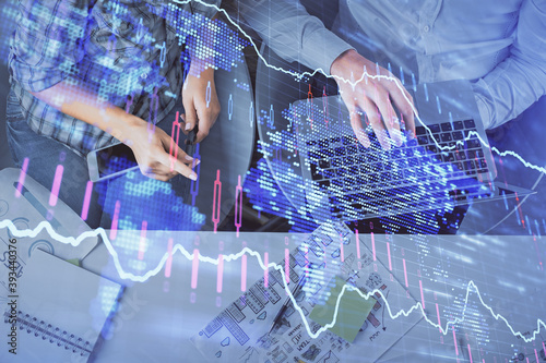 Multi exposure of man and woman working together and forex graph hologram drawing. Financial analysis concept. Computer background. Top View.