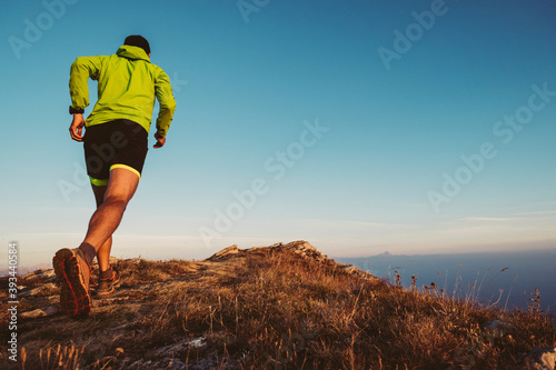 Italy, man running on mountain trail photo