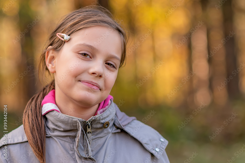 Portrait of a girl in the woods with a beautiful bokeh. 